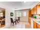 Eat-in kitchen area featuring a glass table, woven chairs, and exterior door and window at 8228 Marshall Ct, Arvada, CO 80003