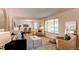 Bright and airy living room featuring an open layout, modern furnishings, and seamless flow to the dining area at 8228 Marshall Ct, Arvada, CO 80003