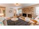 Inviting living room features a brick fireplace, and a playful area with tent at 8228 Marshall Ct, Arvada, CO 80003