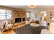 Charming living room with brick fireplace, modern decor, and comfortable seating area at 8228 Marshall Ct, Arvada, CO 80003