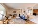 Open-concept living room with hardwood floors, comfortable seating, and stylish accents, perfect for modern living at 8228 Marshall Ct, Arvada, CO 80003