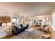 Inviting living room with stylish decor, including a plush sofa, hardwood floors, and bright natural light at 8228 Marshall Ct, Arvada, CO 80003