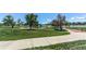Scenic view of a community park featuring walking paths, lush greenery, and a serene lake at 8228 Marshall Ct, Arvada, CO 80003
