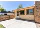 Back patio, complete with neutral-colored siding, access door, and plenty of space for outdoor living at 8228 Marshall Ct, Arvada, CO 80003