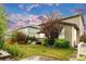 Lush backyard featuring a vibrant lawn, well-placed trees, and a charming deck perfect for relaxation and outdoor activities at 6334 Empire Ave, Frederick, CO 80516
