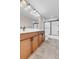 Bathroom features tile floor, wood cabinets and updated sink and shower fixtures at 6334 Empire Ave, Frederick, CO 80516