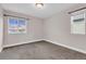 Bedroom features carpet, neutral walls, white trim and two windows at 6334 Empire Ave, Frederick, CO 80516