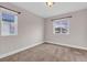 Neutral bedroom with carpet, two windows, and white trim at 6334 Empire Ave, Frederick, CO 80516