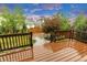 Relaxing deck area with brown wooden railings, offering ample space for outdoor gatherings, with scenic backyard views at 6334 Empire Ave, Frederick, CO 80516