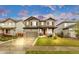 Inviting home with a two-car garage, a cozy front porch, and colorful shutters, set against a backdrop of lush greenery at 6334 Empire Ave, Frederick, CO 80516