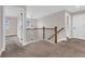 Upstairs hallway showcasing decorative wood banisters and access to bedrooms at 6334 Empire Ave, Frederick, CO 80516