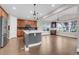 Bright, open eat in kitchen featuring stainless appliances, wooden cabinets, and modern lighting at 6334 Empire Ave, Frederick, CO 80516