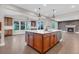 Eat-in kitchen area boasts island, hardwood floors, and a view of the fireplace at 6334 Empire Ave, Frederick, CO 80516