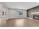 Cozy living room with a stone fireplace, recessed lighting, and a large window offering plenty of natural light at 6334 Empire Ave, Frederick, CO 80516