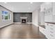 Spacious living room with a fireplace, hardwood floors, and a built-in mudroom area, perfect for entertaining at 6334 Empire Ave, Frederick, CO 80516