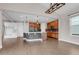 Open concept living room with kitchen and eat in nook with hardwood flooring and island seating at 6334 Empire Ave, Frederick, CO 80516