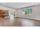 Spacious living room features wood floors, modern lighting, and a large window for natural light at 6334 Empire Ave, Frederick, CO 80516