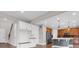 The mud room has white cabinets, built-in storage, and dark hardwood flooring at 6334 Empire Ave, Frederick, CO 80516