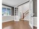 Home office with wood floors, a large window, and decorative French doors leading to the entrance hall at 6334 Empire Ave, Frederick, CO 80516