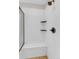 White tile shower with dark bronze fixtures includes a built-in bench and shelving at 6334 Empire Ave, Frederick, CO 80516