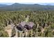 Stunning aerial view of a home nestled among lush trees, showcasing the vast and serene surrounding landscape at 11421 Belle Meade Dr, Conifer, CO 80433