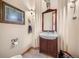 Cozy half-bathroom with dark wood vanity and unique wall decor at 11421 Belle Meade Dr, Conifer, CO 80433