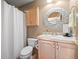 Well-lit bathroom featuring a vanity with storage and decorative mirror above the sink at 11421 Belle Meade Dr, Conifer, CO 80433