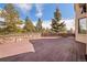 Expansive wooden deck with stone retaining wall and metal railing offers scenic views at 11421 Belle Meade Dr, Conifer, CO 80433