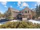 Beautiful exterior view of a multi-story home with a deck and hot tub nestled among trees at 11421 Belle Meade Dr, Conifer, CO 80433