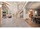 Bright foyer boasts soaring ceilings, stone fireplace, elegant staircase and wood floors at 11421 Belle Meade Dr, Conifer, CO 80433