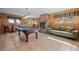 Entertaining game room with billiard table and cozy stone fireplace at 11421 Belle Meade Dr, Conifer, CO 80433