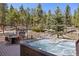 Outdoor hot tub and patio with dining area for relaxation and entertaining at 11421 Belle Meade Dr, Conifer, CO 80433
