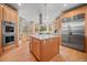 Spacious kitchen with an island and stainless steel appliances at 11421 Belle Meade Dr, Conifer, CO 80433