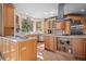 Bright, spacious kitchen with custom cabinets, modern appliances, and a large window overlooking the backyard at 11421 Belle Meade Dr, Conifer, CO 80433