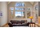 Bright living room with large windows offering scenic mountain views at 11421 Belle Meade Dr, Conifer, CO 80433