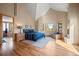 Bright bedroom with hardwood floors, a fireplace, and large windows offering serene outdoor views at 11421 Belle Meade Dr, Conifer, CO 80433