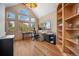 Bright office features vaulted ceilings, large windows, and custom wood built-ins at 11421 Belle Meade Dr, Conifer, CO 80433