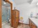 Cozy bathroom with standing shower, a wooden armoire, and a unique decorative chair at 10101 W 72Nd Ave, Arvada, CO 80005