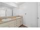 Bathroom with double sinks, large mirror and white cabinets at 10101 W 72Nd Ave, Arvada, CO 80005