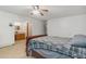 Bedroom with ceiling fan and bathroom featuring vanity with light-toned cabinets at 10101 W 72Nd Ave, Arvada, CO 80005
