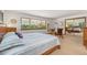 Bright bedroom with large window, sliding mirror closet, and plush carpet at 10101 W 72Nd Ave, Arvada, CO 80005