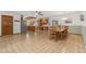 Spacious dining area with tile flooring, wooden table, and view to the kitchen at 10101 W 72Nd Ave, Arvada, CO 80005
