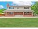 Beautiful brick home featuring a covered porch, large windows, and meticulously kept front lawn at 10101 W 72Nd Ave, Arvada, CO 80005