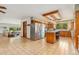 Bright kitchen featuring tile flooring, custom cabinets, and an island at 10101 W 72Nd Ave, Arvada, CO 80005