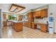 Traditional kitchen with wood cabinets, tile floors, and granite countertops at 10101 W 72Nd Ave, Arvada, CO 80005