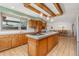 Beautiful kitchen with granite countertops, wooden cabinets, and a large island at 10101 W 72Nd Ave, Arvada, CO 80005