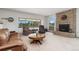 Cozy living room with a brick fireplace, large windows, and comfortable seating at 10101 W 72Nd Ave, Arvada, CO 80005