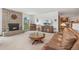 Cozy living room featuring a brick fireplace, comfortable seating, and bright natural light at 10101 W 72Nd Ave, Arvada, CO 80005