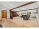Spacious living room features a brick fireplace and wood beams at 10101 W 72Nd Ave, Arvada, CO 80005