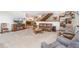 Open-concept living room featuring neutral decor and a view to the dining area at 10101 W 72Nd Ave, Arvada, CO 80005